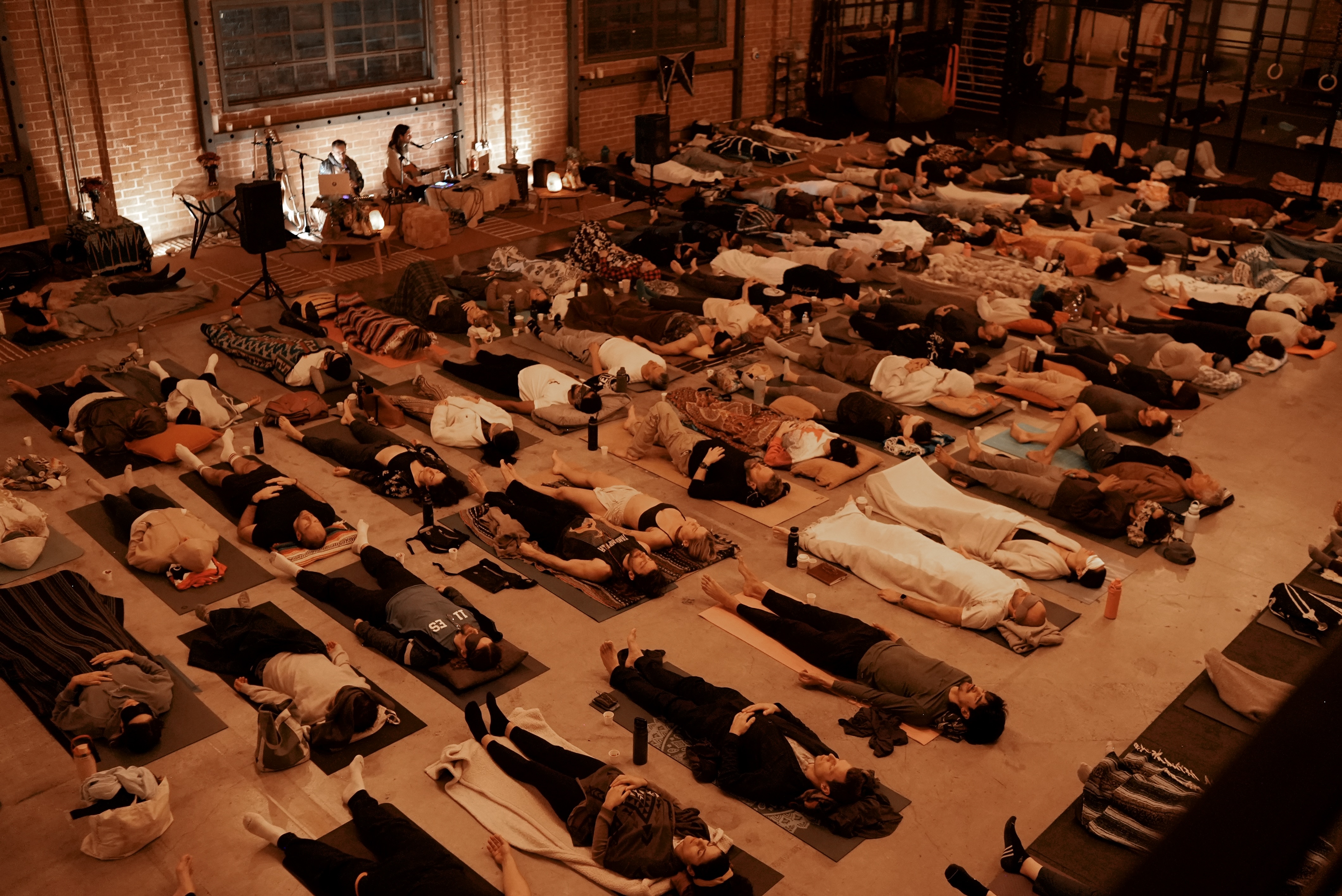 Aerial view of a full room of participants lying down during a live breathwork event